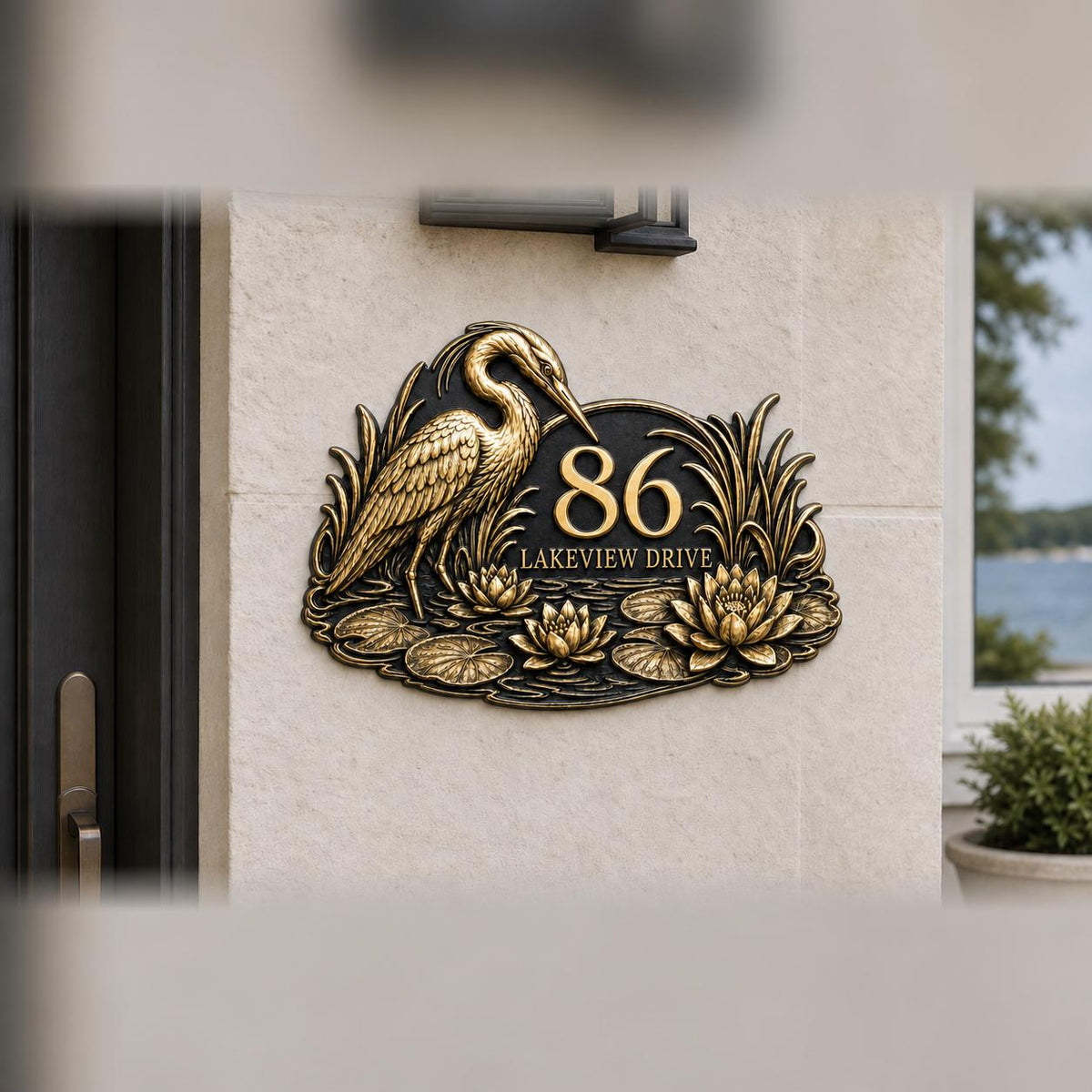 Heron and Waterlilies plaque in antique brass, pictured on a wall